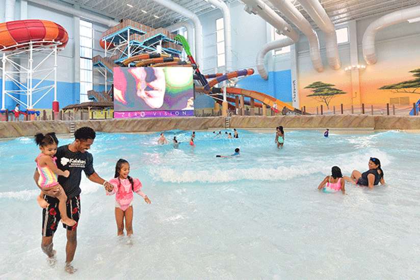 Family enjoying the Kalahari Round Rock waterpark near Odeyso Estates furnished homes